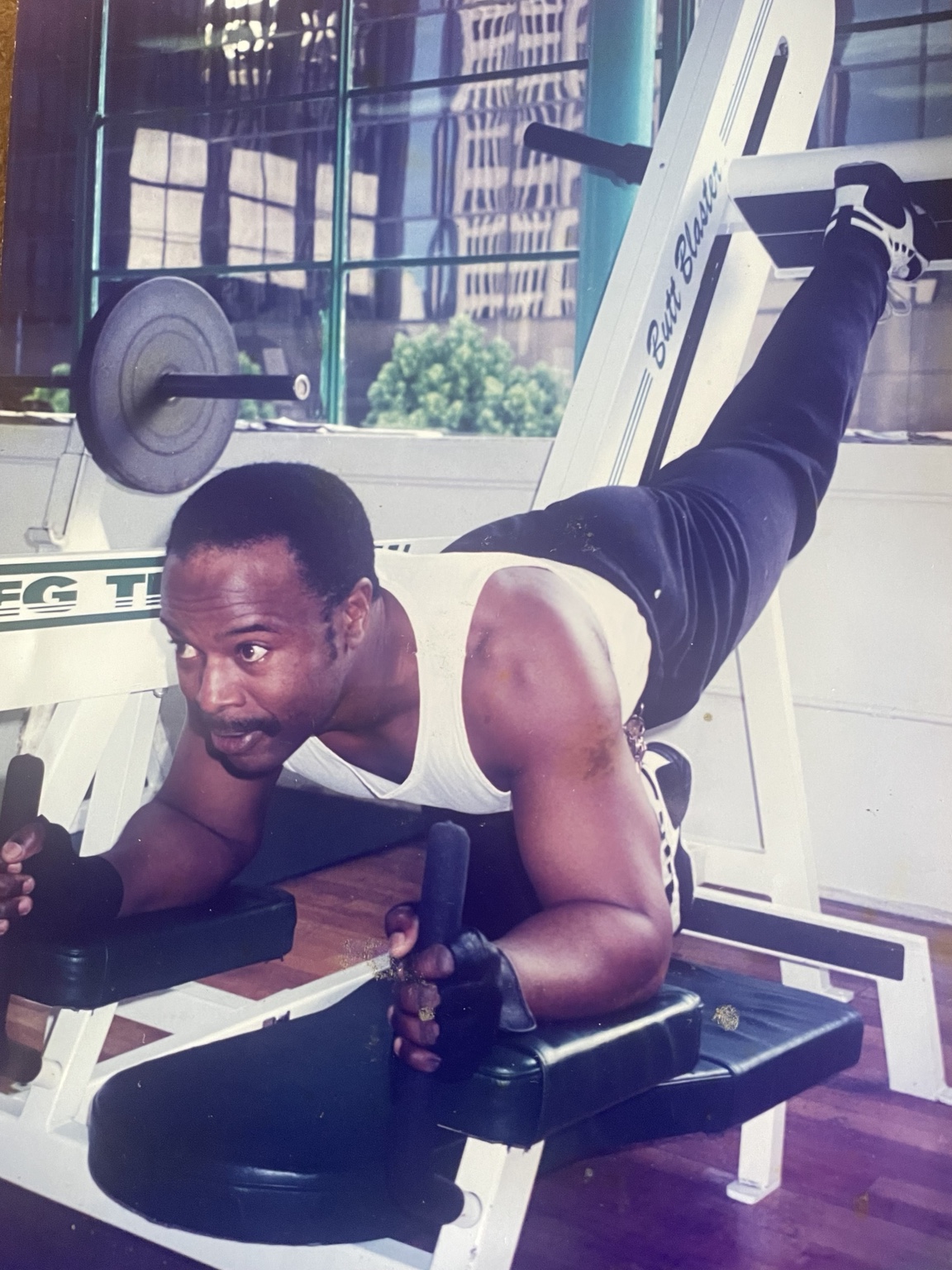 Archival photograph of Ken Taylor training on gym equipment